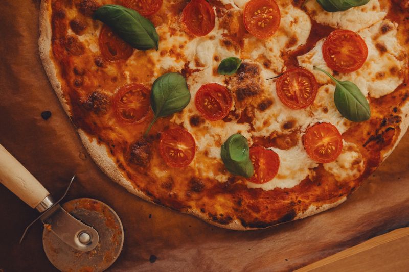 Fresh pizza prepared at Round table pizza kitchen